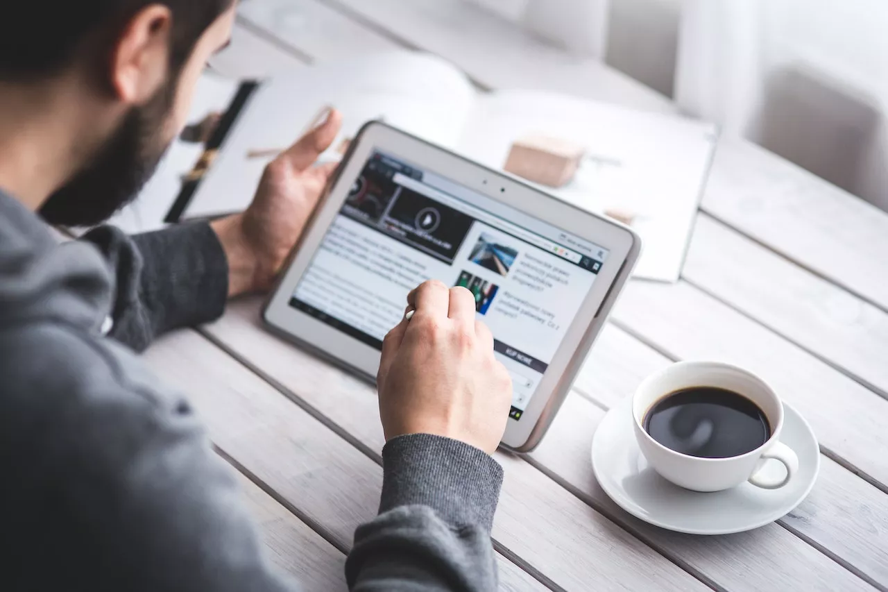 man looking at tablet screen